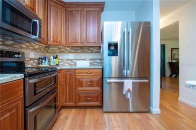 Wow. Don't miss this stylish, serene villa in Sarasota's 55+ on Village Green Golf Club of Sarasota in Florida - for sale on GolfHomes.com, golf home, golf lot