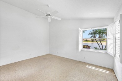 Lakefront single family home nestled amongst vibrant flowering on Westchester Golf and Country Club in Florida - for sale on GolfHomes.com, golf home, golf lot