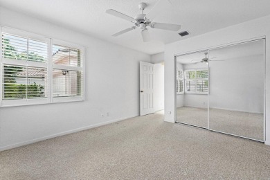 Lakefront single family home nestled amongst vibrant flowering on Westchester Golf and Country Club in Florida - for sale on GolfHomes.com, golf home, golf lot
