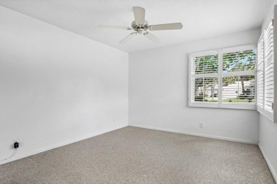 Lakefront single family home nestled amongst vibrant flowering on Westchester Golf and Country Club in Florida - for sale on GolfHomes.com, golf home, golf lot