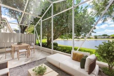 Lakefront single family home nestled amongst vibrant flowering on Westchester Golf and Country Club in Florida - for sale on GolfHomes.com, golf home, golf lot