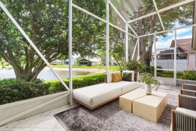 Lakefront single family home nestled amongst vibrant flowering on Westchester Golf and Country Club in Florida - for sale on GolfHomes.com, golf home, golf lot