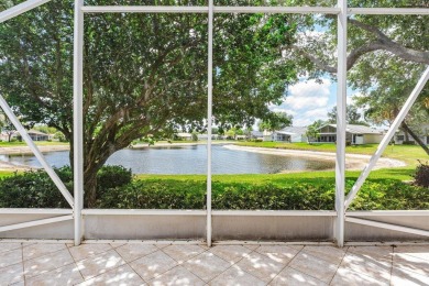 Lakefront single family home nestled amongst vibrant flowering on Westchester Golf and Country Club in Florida - for sale on GolfHomes.com, golf home, golf lot