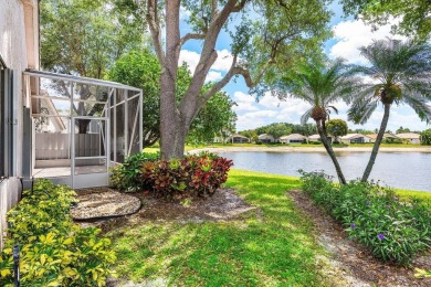 Lakefront single family home nestled amongst vibrant flowering on Westchester Golf and Country Club in Florida - for sale on GolfHomes.com, golf home, golf lot