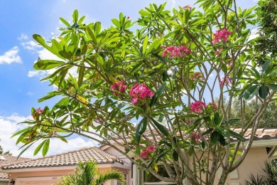Lakefront single family home nestled amongst vibrant flowering on Westchester Golf and Country Club in Florida - for sale on GolfHomes.com, golf home, golf lot