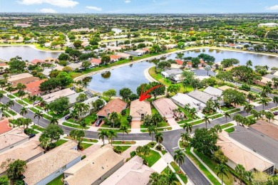 Lakefront single family home nestled amongst vibrant flowering on Westchester Golf and Country Club in Florida - for sale on GolfHomes.com, golf home, golf lot