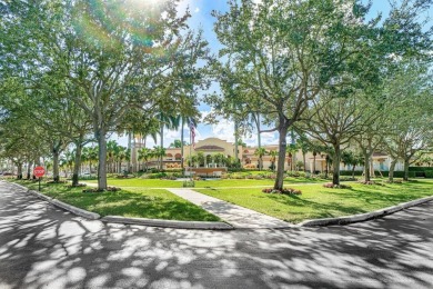 Lakefront single family home nestled amongst vibrant flowering on Westchester Golf and Country Club in Florida - for sale on GolfHomes.com, golf home, golf lot