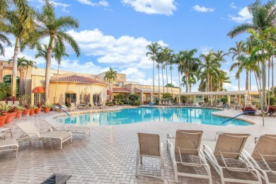 Lakefront single family home nestled amongst vibrant flowering on Westchester Golf and Country Club in Florida - for sale on GolfHomes.com, golf home, golf lot