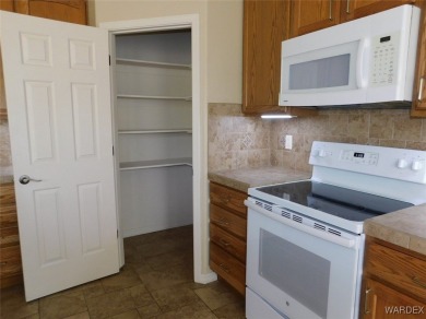 Home is located on a large lot. New interior paint, ceiling fans on Laughlin Ranch Golf Club in Arizona - for sale on GolfHomes.com, golf home, golf lot