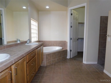 Home is located on a large lot. New interior paint, ceiling fans on Laughlin Ranch Golf Club in Arizona - for sale on GolfHomes.com, golf home, golf lot