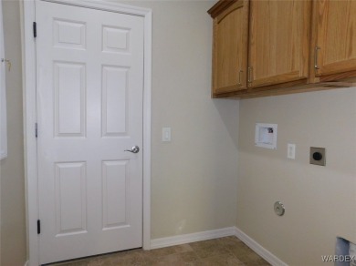 Home is located on a large lot. New interior paint, ceiling fans on Laughlin Ranch Golf Club in Arizona - for sale on GolfHomes.com, golf home, golf lot