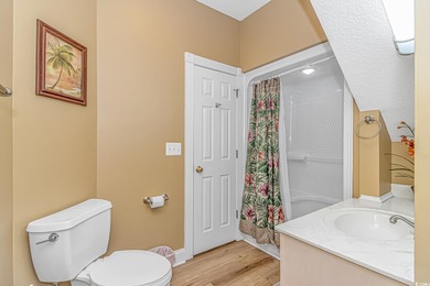 This LAKE FRONT 5 bedroom 3.5  bath raised beach house with on Prestwick Country Club in South Carolina - for sale on GolfHomes.com, golf home, golf lot