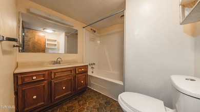 This spacious 4-bedroom, 3-bath home offers incredible potential on Country Club of Bristol in Tennessee - for sale on GolfHomes.com, golf home, golf lot