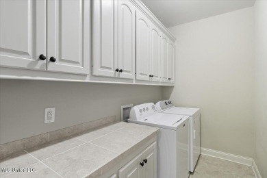 Welcome home to this charming 3-bedroom, 2-bath residence in the on Lake Caroline Golf Club in Mississippi - for sale on GolfHomes.com, golf home, golf lot