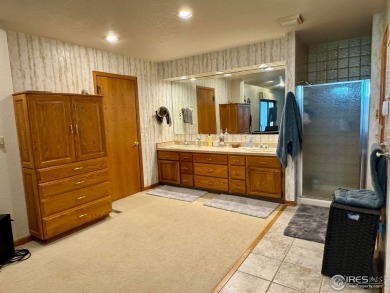 Surrounded by 40 trees, and nestled in a spacious, desirable on Pawnee Pines Golf Club in Colorado - for sale on GolfHomes.com, golf home, golf lot