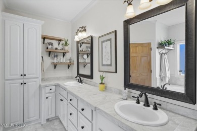 Welcome home to this charming 3-bedroom, 2-bath residence in the on Lake Caroline Golf Club in Mississippi - for sale on GolfHomes.com, golf home, golf lot