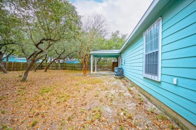 Nestled beneath large shade oak trees, this fully furnished on Rockport Country Club in Texas - for sale on GolfHomes.com, golf home, golf lot