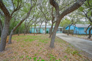 Nestled beneath large shade oak trees, this fully furnished on Rockport Country Club in Texas - for sale on GolfHomes.com, golf home, golf lot