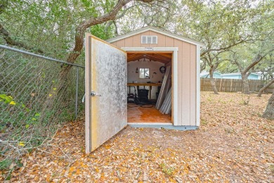 Nestled beneath large shade oak trees, this fully furnished on Rockport Country Club in Texas - for sale on GolfHomes.com, golf home, golf lot