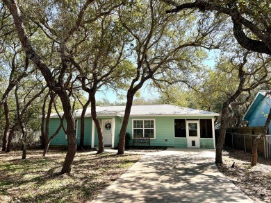 Nestled beneath large shade oak trees, this fully furnished on Rockport Country Club in Texas - for sale on GolfHomes.com, golf home, golf lot