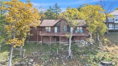 This home boasts a view like few others can perched high on a on Holiday Island Executive Golf Course in Arkansas - for sale on GolfHomes.com, golf home, golf lot