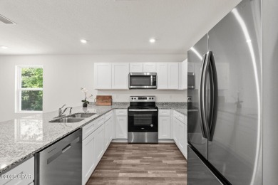 Tucked into a peaceful, wooded setting with no neighbors to the on Sunny Hills Golf and Country Club in Florida - for sale on GolfHomes.com, golf home, golf lot