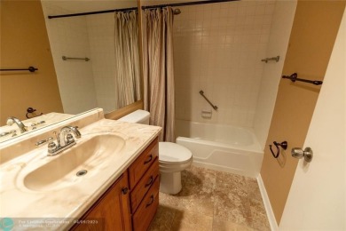 A breathtaking view and a peaceful living environment where life on Wynmoor Golf Course in Florida - for sale on GolfHomes.com, golf home, golf lot