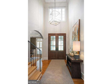 Discover timeless elegance and modern comfort in this on Woodmont Golf and Country Club in Georgia - for sale on GolfHomes.com, golf home, golf lot