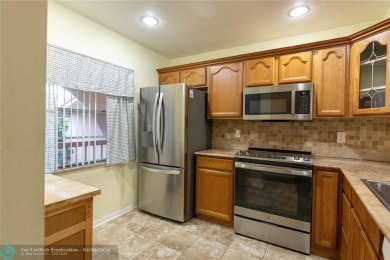 A breathtaking view and a peaceful living environment where life on Wynmoor Golf Course in Florida - for sale on GolfHomes.com, golf home, golf lot
