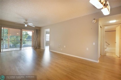 A breathtaking view and a peaceful living environment where life on Wynmoor Golf Course in Florida - for sale on GolfHomes.com, golf home, golf lot