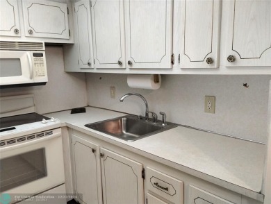 AFFORDABLE WINTER GET-AWAY!! GROUND FLOOR IN MOVE-IN CONDITION on Hillsboro Pines Golf in Florida - for sale on GolfHomes.com, golf home, golf lot