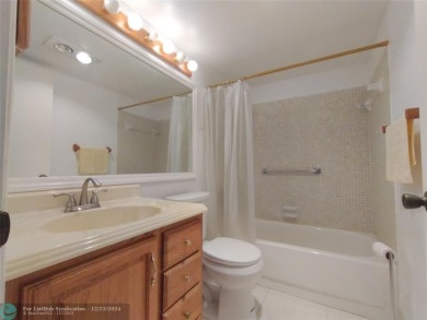 AFFORDABLE WINTER GET-AWAY!! GROUND FLOOR IN MOVE-IN CONDITION on Hillsboro Pines Golf in Florida - for sale on GolfHomes.com, golf home, golf lot