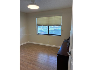 Elevated living meets total convenience in this charming on Sunrise Lakes Phase IV Golf Course in Florida - for sale on GolfHomes.com, golf home, golf lot