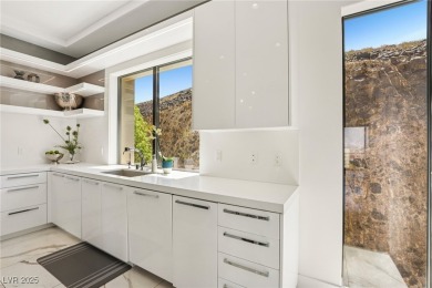Experience sweeping Strip and mountain views from this elegant on Dragon Ridge Country Club in Nevada - for sale on GolfHomes.com, golf home, golf lot