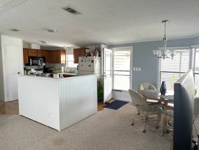 CHECK OUT THIS BEAUTIFUL, BRIGHT AND VIBRANT HOME IN ANGLERS on Anglers Green Golf Course in Florida - for sale on GolfHomes.com, golf home, golf lot