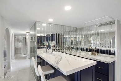 Discover luxury living with stunning mountain, lake, pond, and on London Bridge Golf Course in Arizona - for sale on GolfHomes.com, golf home, golf lot