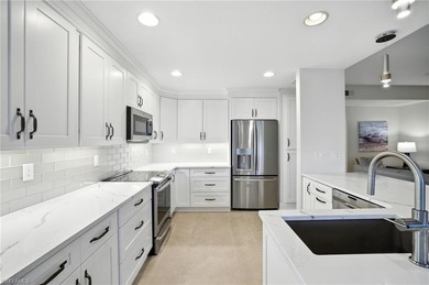 Stunning, completely remodeled end-unit first-floor coach home on West Bay Beach and Golf Club in Florida - for sale on GolfHomes.com, golf home, golf lot