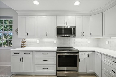 Stunning, completely remodeled end-unit first-floor coach home on West Bay Beach and Golf Club in Florida - for sale on GolfHomes.com, golf home, golf lot