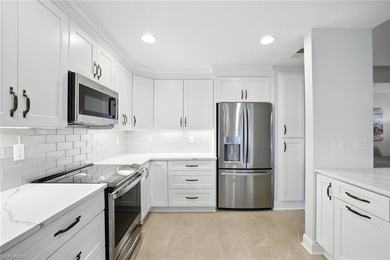 Stunning, completely remodeled end-unit first-floor coach home on West Bay Beach and Golf Club in Florida - for sale on GolfHomes.com, golf home, golf lot