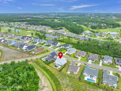 Welcome to 5083 Creswell Drive, a true gem located in the highly on Cape Fear National At Brunswick Forest in North Carolina - for sale on GolfHomes.com, golf home, golf lot