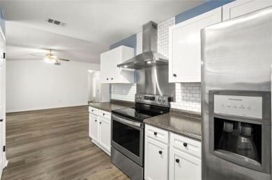 This remodeled 3-bedroom, 2-bath brick home is centrally located on Lake Forest Yacht and Country Club in Alabama - for sale on GolfHomes.com, golf home, golf lot