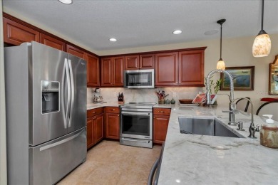 Step inside and be greeted by sweeping golf course views from on Summerglen Country Club in Florida - for sale on GolfHomes.com, golf home, golf lot