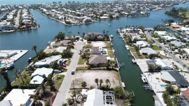 Here is your perfect chance to build your dream waterfront home on Key Royale Club in Florida - for sale on GolfHomes.com, golf home, golf lot