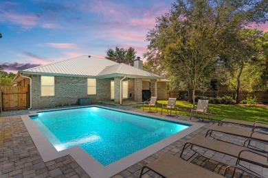 Nestled on an oversized lot, this single-level brick home in on Santa Rosa Golf and Beach Club in Florida - for sale on GolfHomes.com, golf home, golf lot