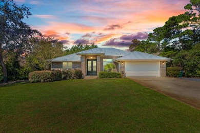 Nestled on an oversized lot, this single-level brick home in on Santa Rosa Golf and Beach Club in Florida - for sale on GolfHomes.com, golf home, golf lot