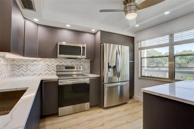 Enjoy resort-style living in Wynmoor's sought-after Antigua I on Wynmoor Golf Course in Florida - for sale on GolfHomes.com, golf home, golf lot