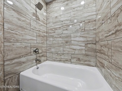 Want a comfortable cabin at the lake? This home offers wooded on The Greens at Deerfield in Tennessee - for sale on GolfHomes.com, golf home, golf lot