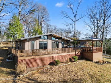 Want a comfortable cabin at the lake? This home offers wooded on The Greens at Deerfield in Tennessee - for sale on GolfHomes.com, golf home, golf lot