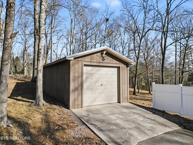 Want a comfortable cabin at the lake? This home offers wooded on The Greens at Deerfield in Tennessee - for sale on GolfHomes.com, golf home, golf lot
