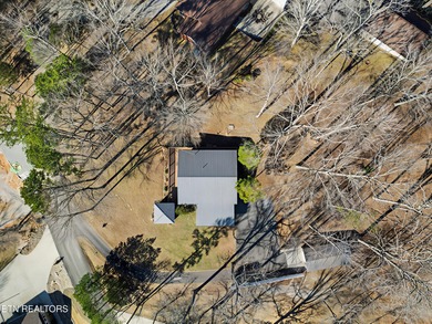 Want a comfortable cabin at the lake? This home offers wooded on The Greens at Deerfield in Tennessee - for sale on GolfHomes.com, golf home, golf lot